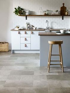 a kitchen counter with two stools in front of it