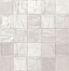 a white tile wall that is very clean and ready to be used as a background