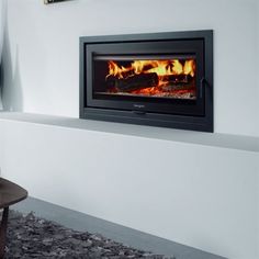 a room with a fire place in the wall and a chair on the floor next to it