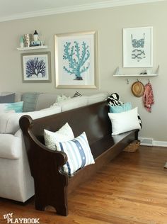 a living room filled with furniture and pictures on the wall