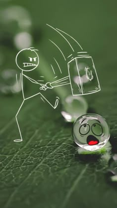 a glass ball with a drawing of a person pulling something out of the water on top of it