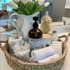 a basket filled with white flowers and personal care items