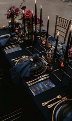 the table is set with candles and place settings