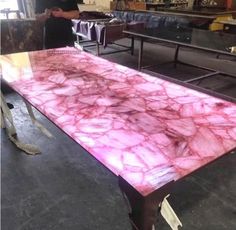 a table with pink marble on it in a room