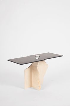 a table that has been made out of wood and is in the shape of a piece of paper