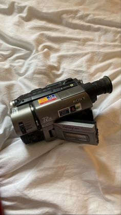 an old camera is laying on the bed