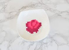 a white bowl with a red heart on it