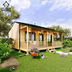 a small wooden house sitting on top of a lush green field