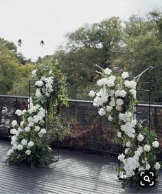 white flowers and greenery are arranged on the roof