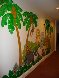 a wall painted with jungle animals and palm trees