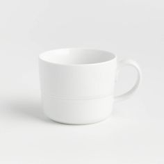 a white cup sitting on top of a table