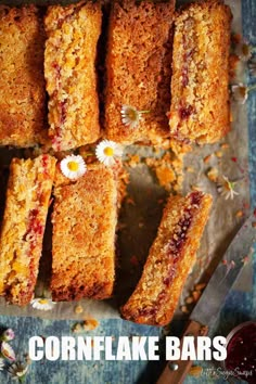 several pieces of cake sitting on top of a table next to a knife and fork