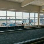 an airport terminal with people waiting for their planes to take them home from the airport