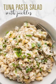 tuna pasta salad with pickles in a white bowl on a marble countertop and text overlay that says tuna pasta salad with pickles