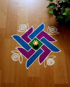 an artistic design on the floor in front of a potted plant