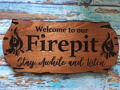 a wooden sign that says, welcome to our firepit stay awhile and listen on