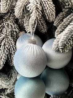 blue and white ornaments hanging from a christmas tree