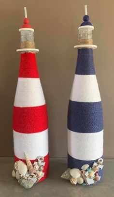 two wine bottles decorated with red, white and blue buoys are sitting next to each other