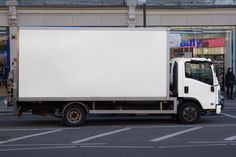 a white truck is parked on the street