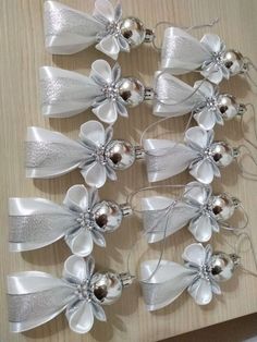 several silver and white bows with bells on them