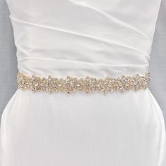 Bridal Gold Belt, Bridal Belt Gold, Gold Bridal Belt for Wedding Dress Sparkle on your special day with our Bridal Gold Belt. Shine bright as a modern bride with this dazzling accessory. 💖 Details - Embellishment measures approximately 17.75 inches long and 1.2 inches wide - Ribbon measures 106 inches long - Ivory ribbon - Handmade with sparkling rhinestones 💖 Packaging Each accessory is delicately packaged in our exclusive soft and luxe velvet bag, ensuring its pristine condition until your special day. 💖 Shipping This item is currently in stock, and will be shipped within 2 business days from NY 💖 Returns & Exchanges At bridal accessories shop, we understand that planning your dream wedding can be a whirlwind, and your desire to look like the most beautiful bride in the world. Theref Elegant Gold Bridal Accessories With Sashes, Elegant Gold Wedding Dress For Ceremony, Elegant Gold Bridal Belt For Bride, Elegant Gold Bridal Belt, Champagne Rhinestones Wedding Jewelry, Elegant Rhinestone Bridal Accessories For Wedding, Glamorous White Bridal Belt For Wedding, Fitted Gold Sash For Wedding, Elegant Gold Bridal Belt For Bridesmaids