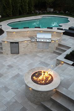 a fire pit sitting next to a swimming pool