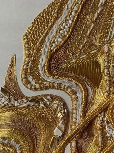 gold and white fabric with intricate designs on it