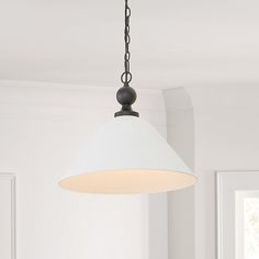 a white light hanging from a ceiling in a room