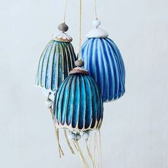 two blue and white ceramic ornaments hanging from strings