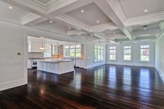 an empty kitchen and living room with hardwood floors