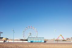 an amusement park with a ferris wheel in the background