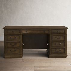 an old fashioned desk with drawers on the bottom and one drawer at the top, in front of a white wall