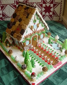 a gingerbread house is decorated with icing and christmas decorations for the holiday season