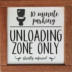 a sign that says no minute parking unloading zone only on the front of a wooden frame