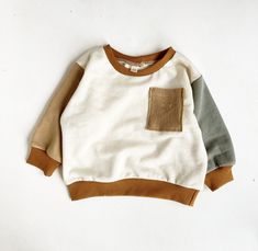 French terry color block sweater. Runs roomy. Fits oversized and baggyish. Matches the button joggers in shop!  Handmade in a smoke free, pet free studio. Hand wash or machine wash on delicate. Line dry.  2-3 week process time. (Although usually it ships sooner.) If you need this by a certain date leave us a note at checkout and we will do our best to help! Color Block Sweatshirt, Colour Blocking, Color Block Sweater, Kids Sweatshirt, Kids Tops, Coloring For Kids, French Terry, Color Block, Gender Neutral