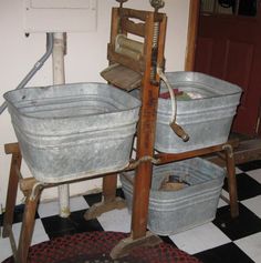 two buckets sitting on top of a black and white checkered floor