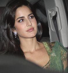 a woman sitting in the back seat of a car