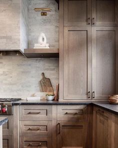 a kitchen with wooden cabinets and marble counter tops