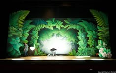 the stage is decorated with green foliage