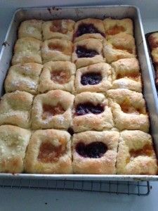 two pans filled with pastries sitting on top of a counter next to each other