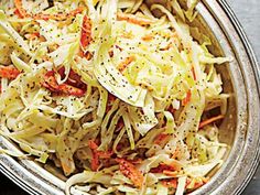 a bowl filled with coleslaw on top of a table