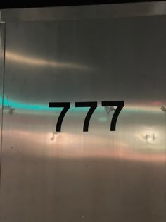 the number 777 is engraved on a stainless steel door