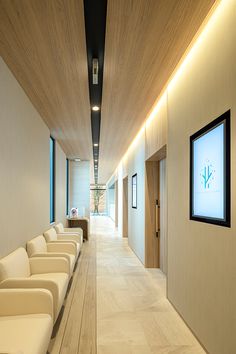 an empty waiting room with white chairs in it