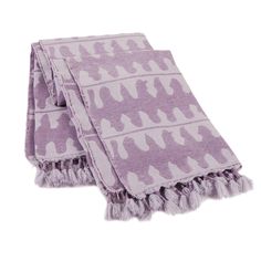 two purple and white towels on top of each other, one with an animal print