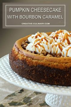 pumpkin cheesecake with bourbon caramel on a white cake platter, topped with whipped cream