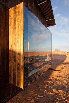 the side of a building with a large glass window on it's outside wall