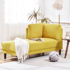 a yellow couch sitting on top of a white rug