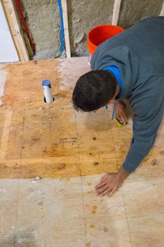 a man is working on the floor in his house