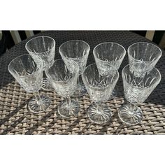 six crystal goblets on a wicker table