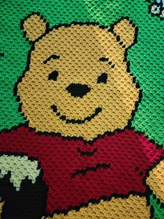 a crocheted photo of a teddy bear with a red t - shirt on